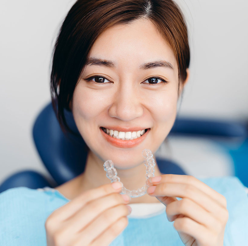 Woman holding clear retainer